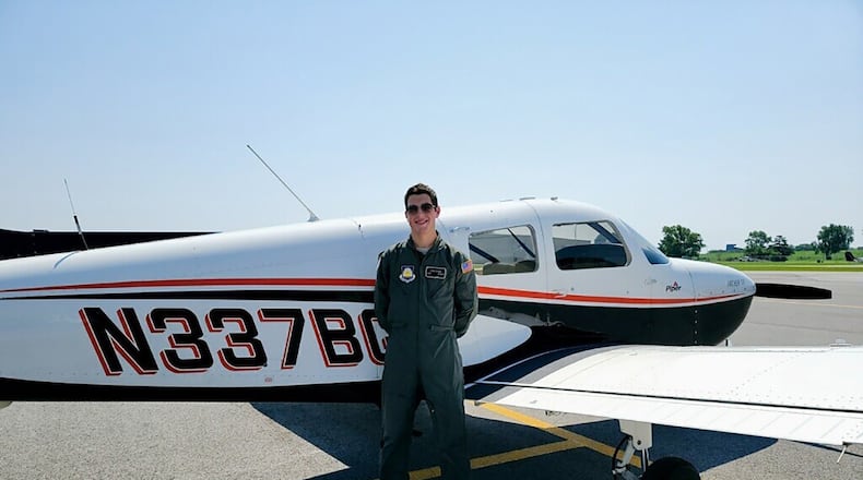 Aaron Staiger, an Air Force Junior ROTC cadet at Beavercreek High School, poses in front of a Piper PA-28-181 single-engine aircraft on July 26 after successfully completing his checkride for a private pilot’s license. CONTRIBUTED PHOTO