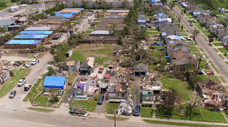 Damage in Old North Dayton from the Memorial Day tornadoes. Debris has been removed from most sidewalks and streets, except for Kelly Avenue. TY GREENLEES / STAFF