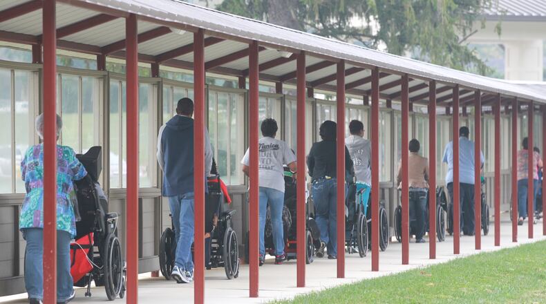 Residents of the Stillwater Center use a new walkway to get from the center to Northview School. Before, many of the residents were traveling about 11 miles by bus for services. CHRIS STEWART / STAFF