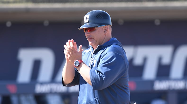 Dayton baseball coach Jayson King claps during a game in 2019. Photo by Erik Schelkun