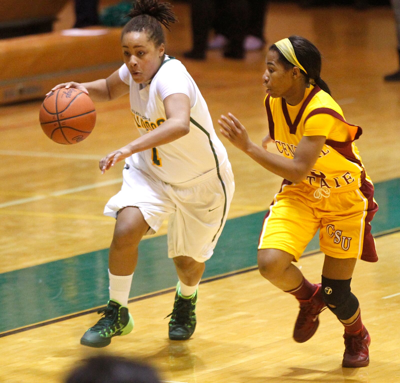 Wilberforce Bulldogs' Martina Brady drives against Central State Marauders' Ashley Watson in Monday night's 99-95 upset win. The game is a huge rivalry for the schools that are across the street from one another. Wilberforce had never beaten CSU. TY GREENLEES / STAFF Tom Archdeacon on Battle of Wilberforce