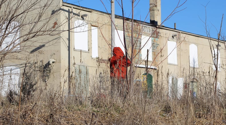 A man walks the train tracks in east Dayton. CORNELIUS FROLIK / STAFF