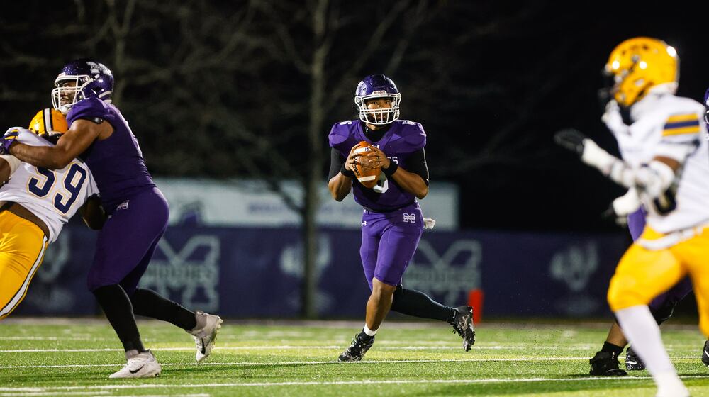 Middletown High School quarterback Joseph Ward rolls out to pass during their game against Springfield on Friday, Nov. 14 at Barnitz Stadium. The Middies won 14-0 to advance to their first regional final since 1990. NICK GRAHAM / STAFF PHOTO