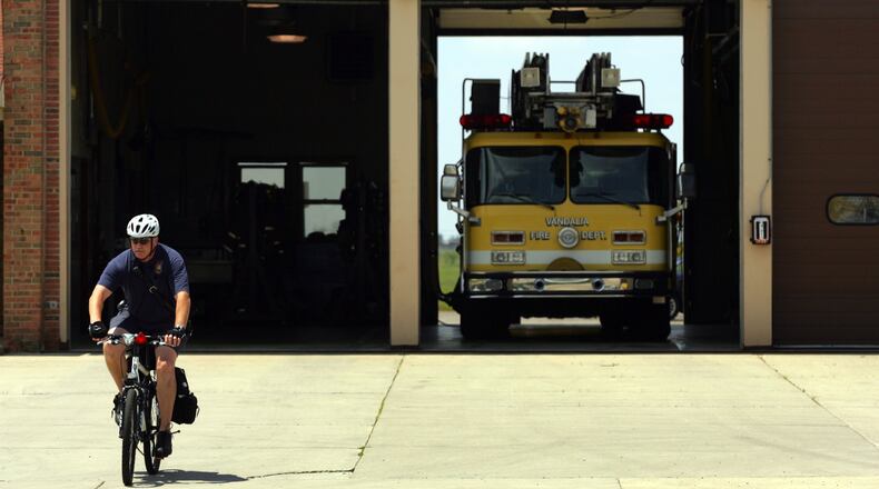 Vandalia has started sending their fire inspectors out on bikes instead of in fire department trucks to do inspections. Inspector Kenny Mann heads out for an inspection on the department cycle to his appointment as a way of reducing gasoline expense in the fire department. Photo by Jim Witmer