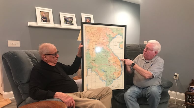 Pat Allen holds a map of Vietnam as Mark Deam points out various areas he was he in during the Vietnam War. Tom Archdeacon/CONTRIBUTED