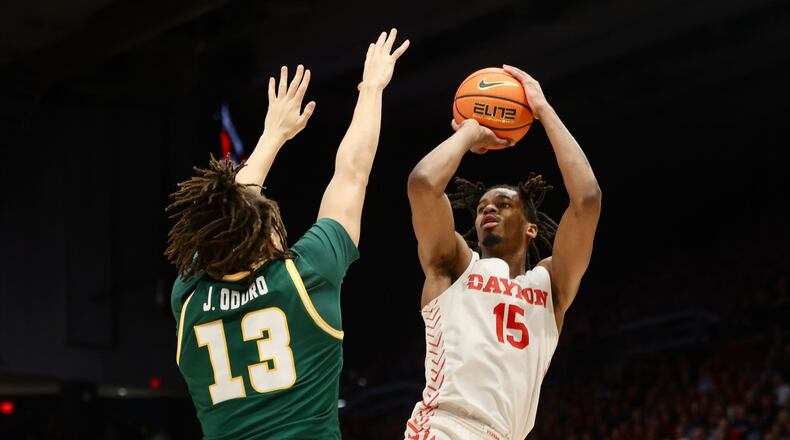 Dayton's DaRon Holmes II shoots against George Mason's Josh Oduro on Saturday, Feb. 25, 2023, at UD Arena. David Jablonski/Staff