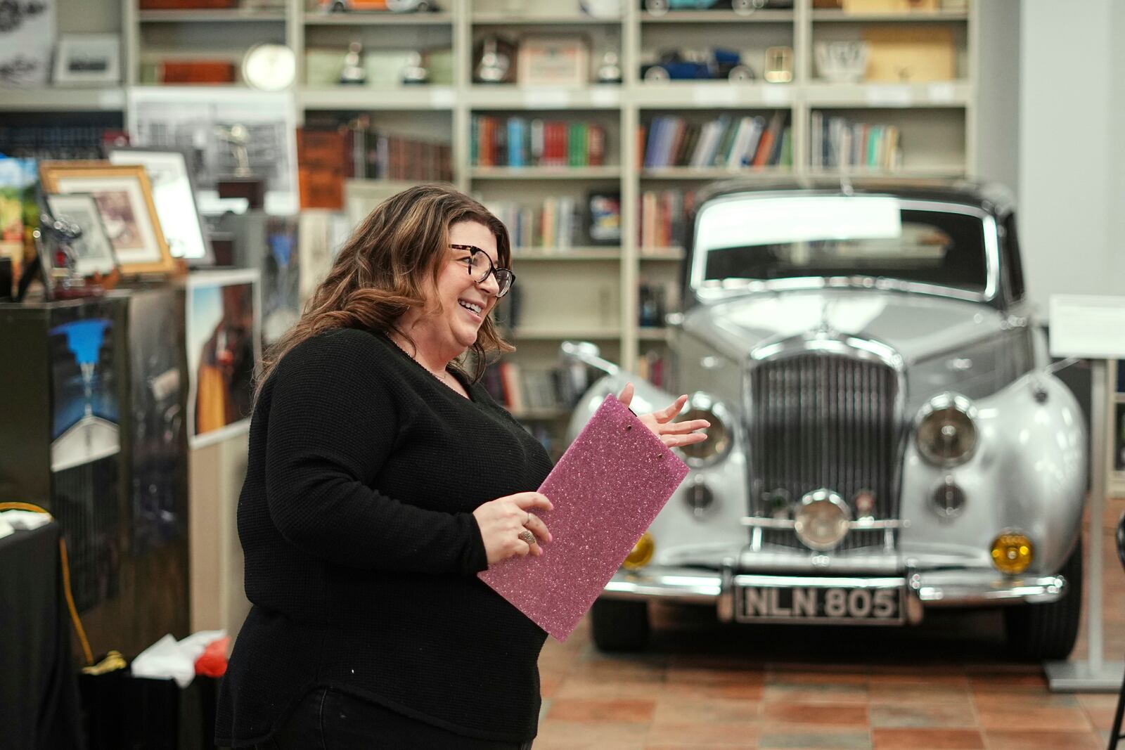 Sarah Holibaugh, head librarian and archivist at The Rolls-Royce Foundation speaks with volunteers in Mechanicsburg, Pa., Saturday, April 5, 2025. (AP Photo/Matt Rourke)