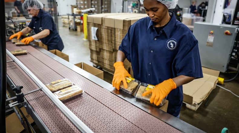 Killer Brownie packing team member Juhuei Eudia packages-up killer brownies at the Miamisburg plant. JIM NOELKER/STAFF