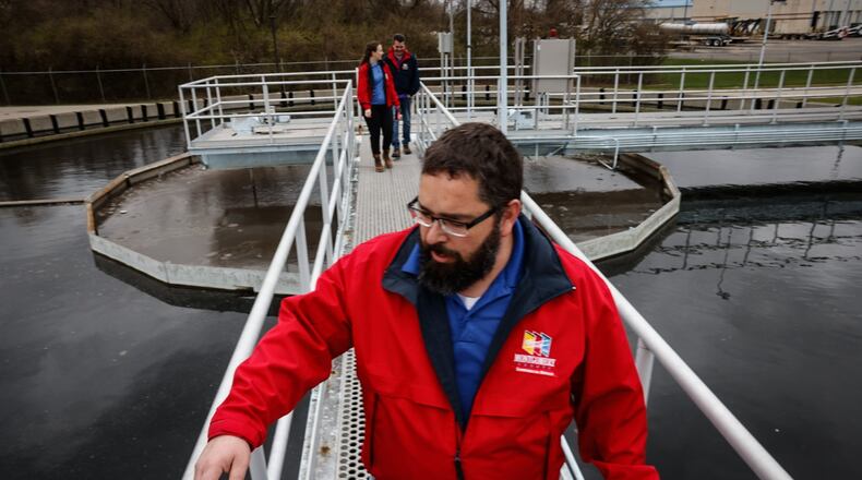 Montgomery County eastern regional water reclamation facility plant manager Donald Hartmen walks across the secondary clarifier on a catwalk at the plant on Spaulding Road Tuesday March 26, 2024. JIM NOELKER/STAFF