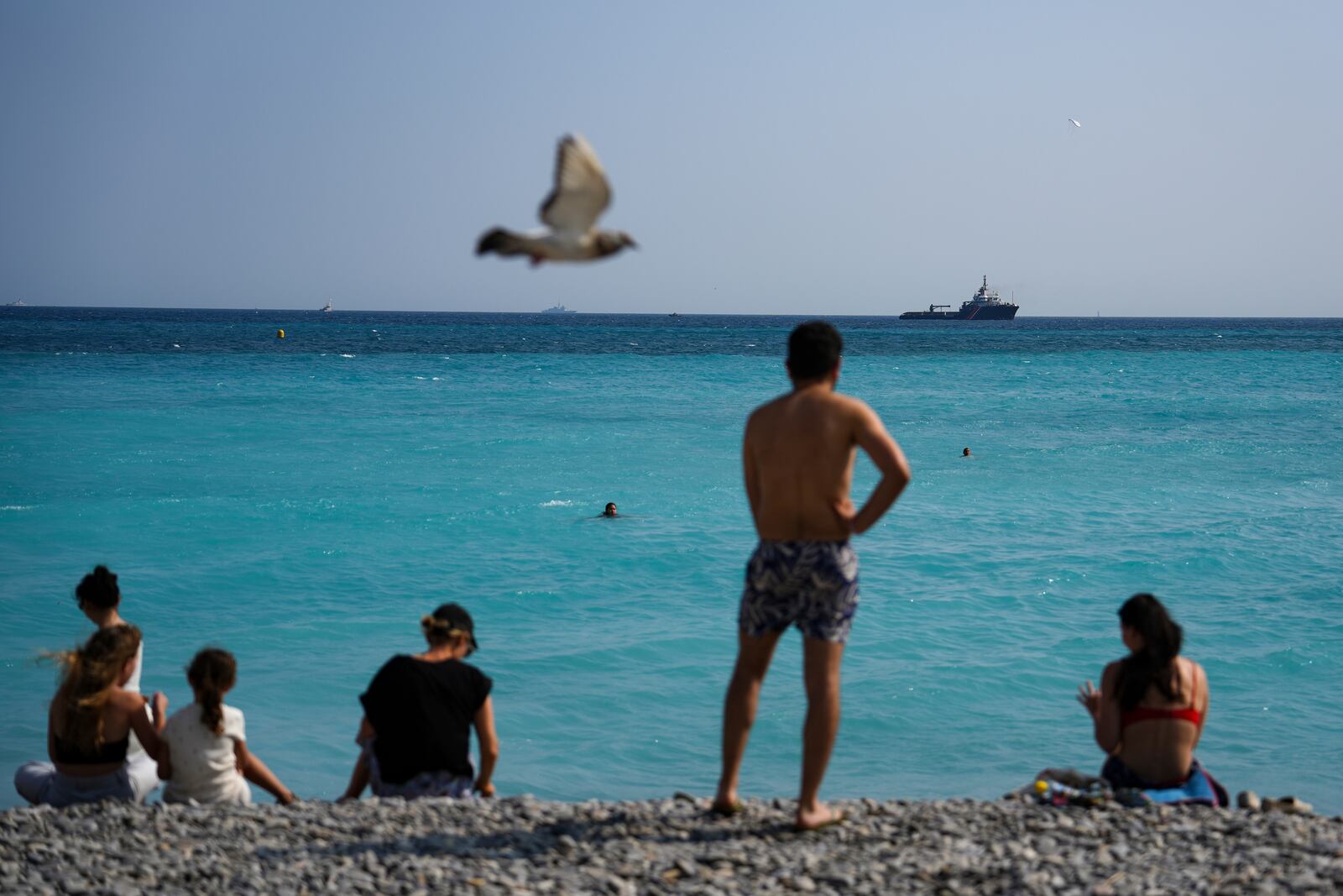 People wacth vessels sail during the "Ocean Wonders" event in honor of World Oceans Day ahead of the U.N. Ocean Conference on Sunday, June 8, 2025, in Nice, France. (AP Photo/Annika Hammerschlag)