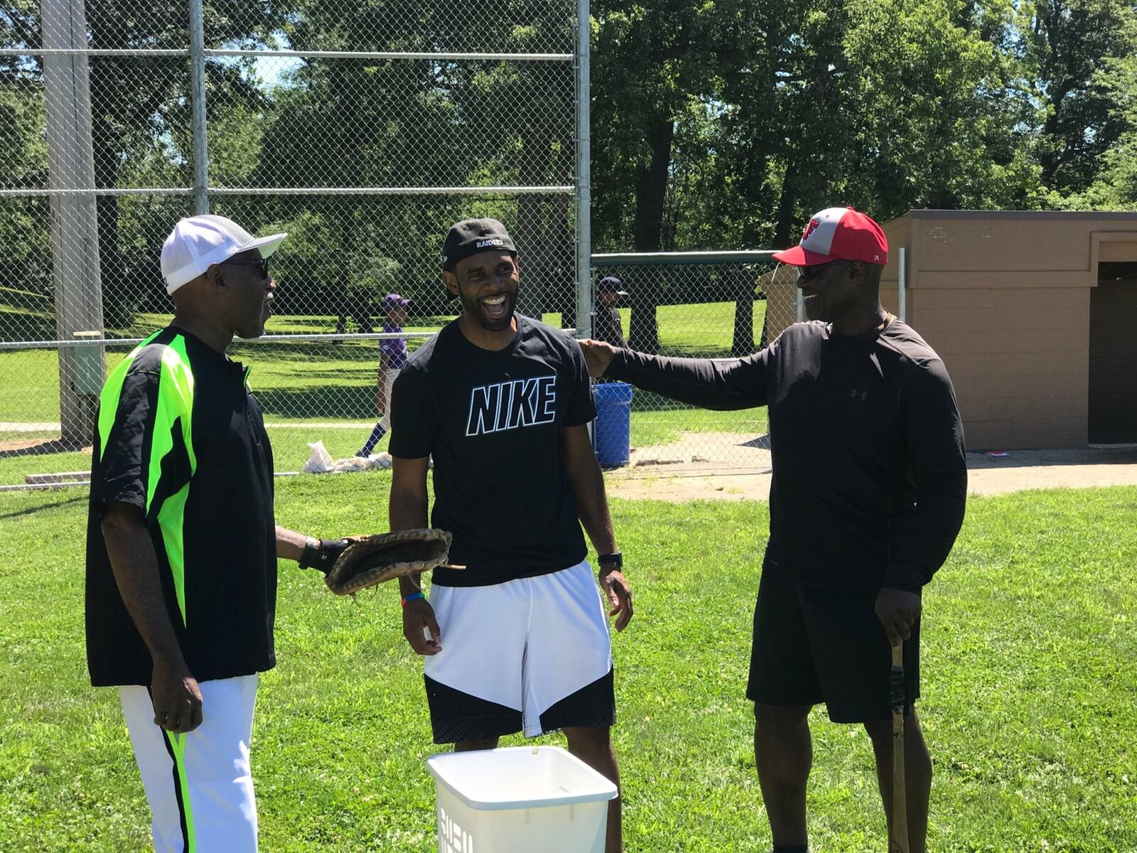 Reds legend George Foster (right), Jonathan Cain (center) and Michael Carter on Saturday at Howell Field in Dayton.TOM ARCHDEACON/STAFF