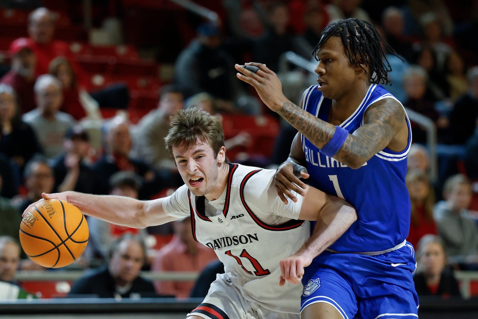 Davidson guard Sam Brown, left, drives against Saint Louis guard Quentin Jones during the first half of an NCAA college basketball game in Davidson, N.C., Tuesday, Feb. 3, 2026. (AP Photo/Nell Redmond)