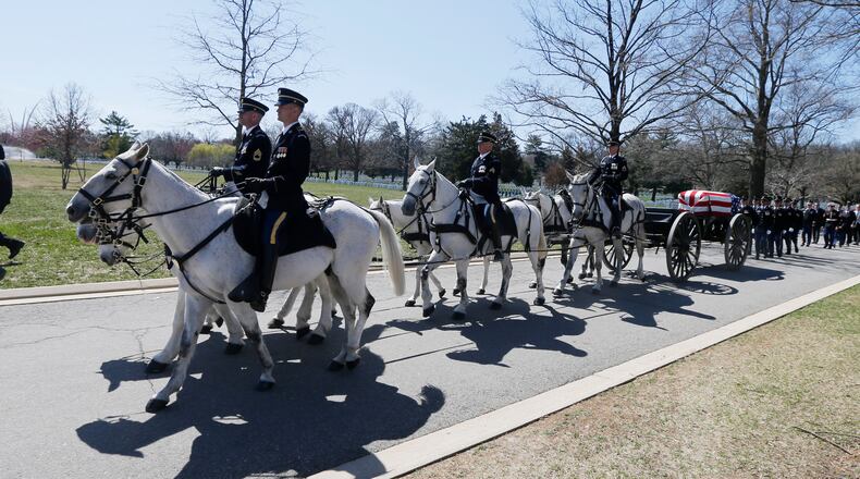 FILE - A U.S. Army Caisson team carries the casket of Lt. Col. Richard Smith during his funeral at Arlington National Cemetery in Arlington, Va., March 28, 2019. The return of horse-drawn caissons at Arlington National Cemetery is being delayed for at least months or a year, the Army said Friday, April 12, 2024, as officials struggle to improve the care of the horses, after two died in 2022 as a result of poor feed and abysmal living conditions. (AP Photo/Steve Helber, File)
