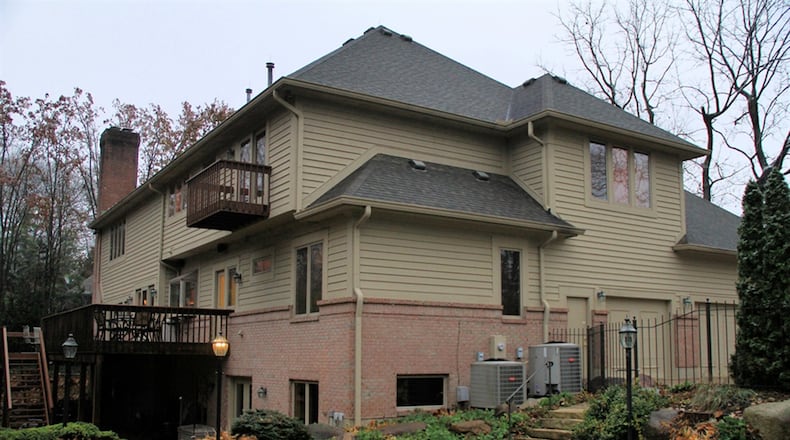 The back yard has an in-ground swimming pool surrounded by paver bricks. The rear deck is accessible from the breakfast room and the main-level family room.