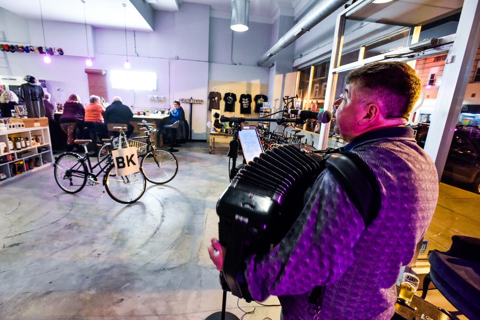 Gerhard Albinus provides muciscal entertainment inside Spoken Bicycles during the First Friday event Friday Feb. 2 in Middletown. NICK GRAHAM/STAFF