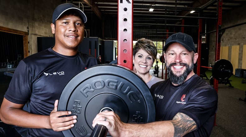 From left, Shane Smith, Hollie Miller and Tony Miller have opened Dayton Functional Fitness on Distribution Drive in Beavercreek. The center has free weights, stationary bikes and rowing machines and soon to have indoor soccer. JIM NOELKER/STAFF