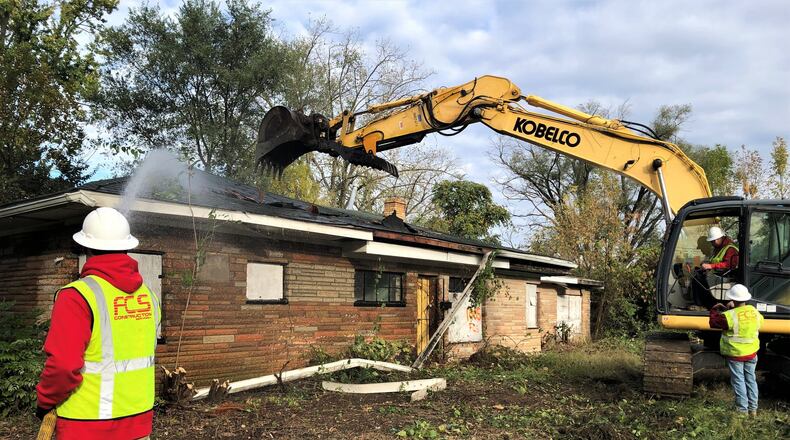 A crew with FCS Construction Services Inc. on Thursday torn down a home on the 1000 block of Roseland Avenue in the Westwood neighborhood. CORNELIUS FROLIK / STAFF