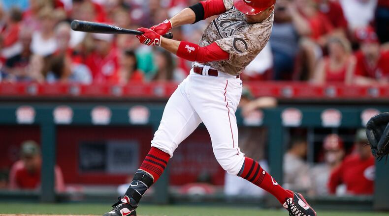 Cincinnati Reds first baseman Joey Votto hits an RBI single off St. Louis Cardinals starting pitcher Mike Leake during the fifth inning of a baseball game, Friday, Aug. 4, 2017, in Cincinnati. The Reds won 3-2. (AP Photo/Gary Landers)