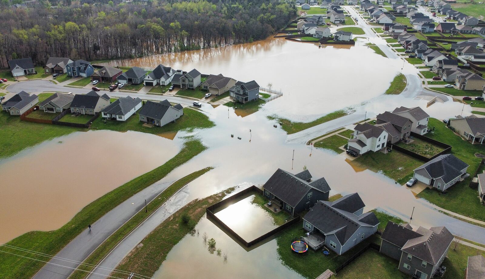 Flood waters cover the entryway to the Weather Stone subdivision off Russellville Road in Bowling Green, Ky., on Friday, April 4, 2025, after excessive rainfall Thursday into Friday drenched southcentral Kentucky with more than four and a half inches of rain. (Grace McDowell /Daily News via AP)