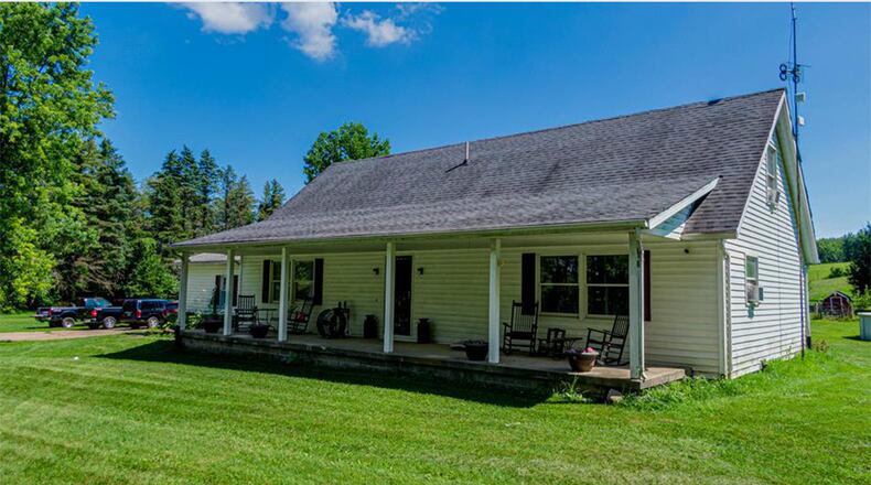 The vinyl-sided home has a full covered front porch with pillars and a side-entry, two-car garage. Contributed photos