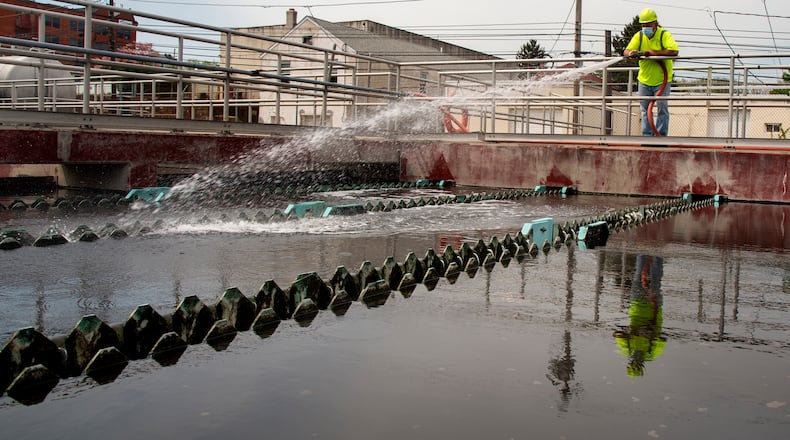 In this April 28, 2021 photo, a man works on the settlement tanks at the Conshohocken, Pa., sewer plant. (Tom Gralish/The Philadelphia Inquirer via AP)