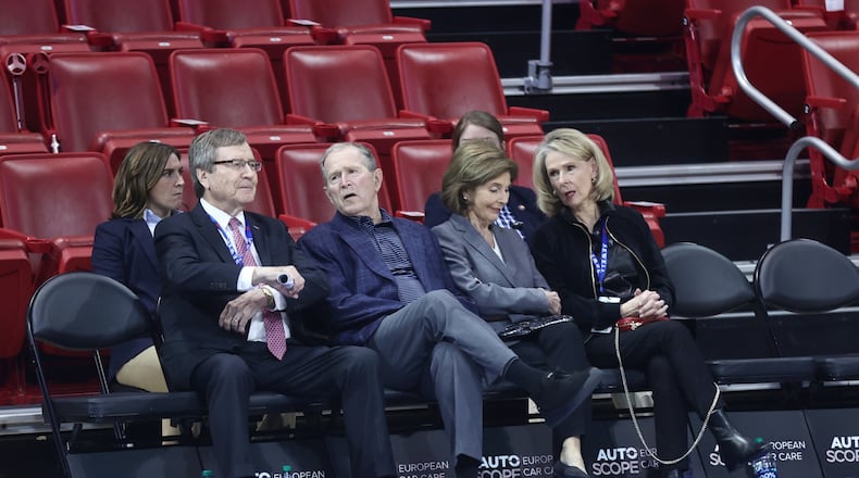 George W. Bush, second from left, and Laura Bush, second from right, sit courtside at Moody Coliseum on Wednesday, Nov. 29, 2023, before a game between Dayton and SMU in Dallas, Texas. David Jablonski/Staff