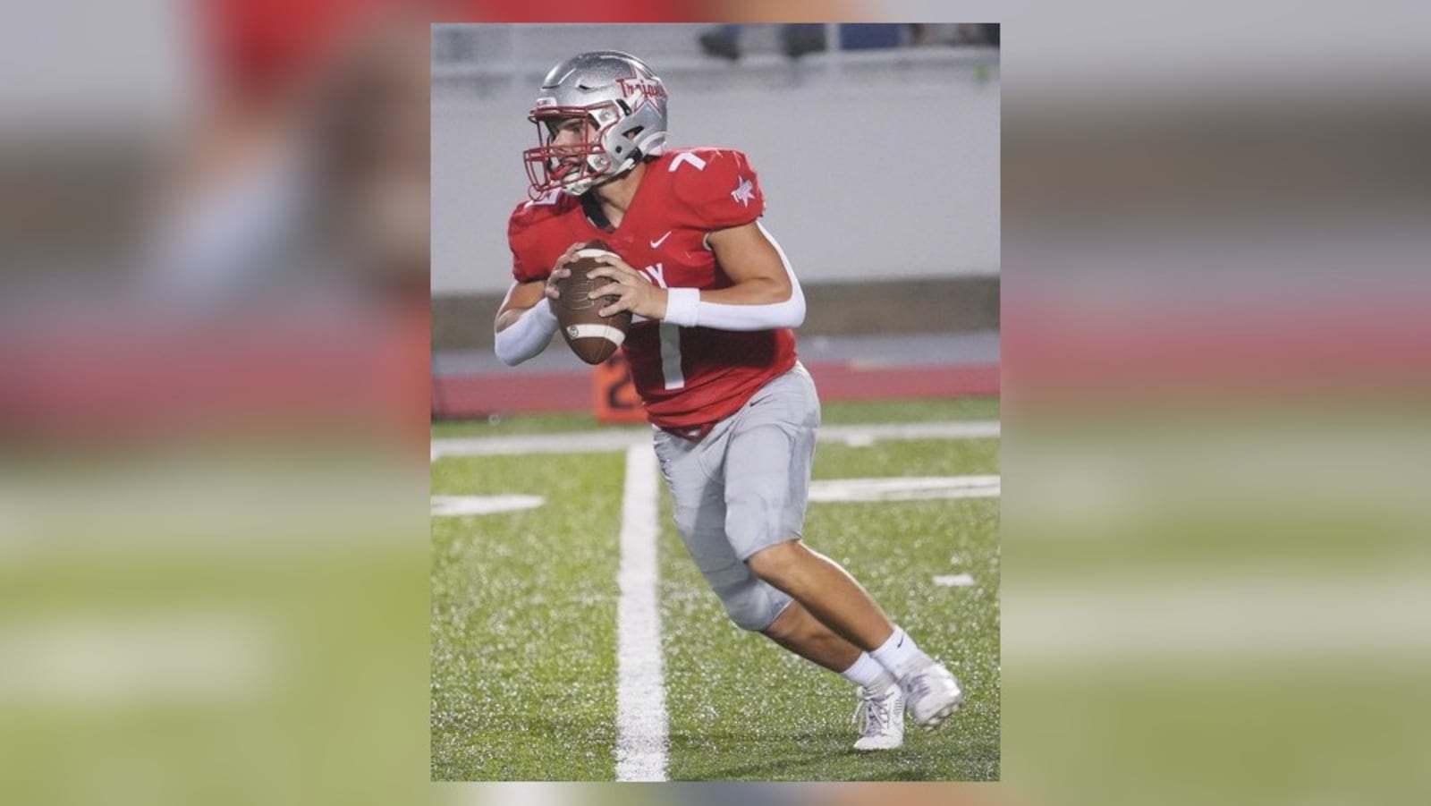 Troy High School senior Aiden Kirkpatrick rolls out to pass during a recent game for the Trojans. TROY CITY SCHOOLS / CONTRIBUTED PHOTO