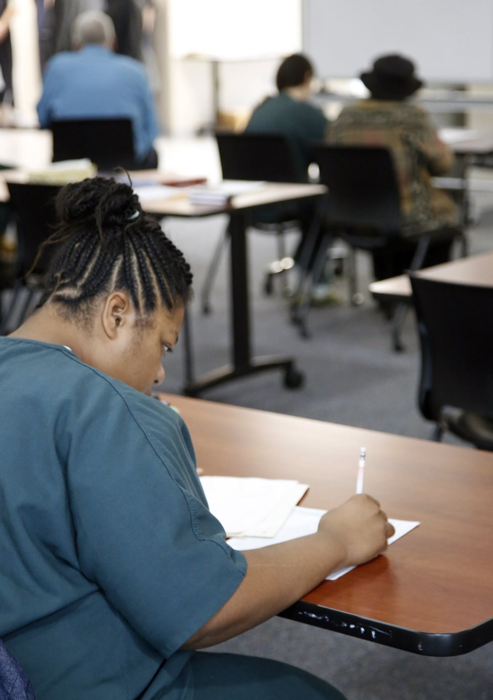 Assistance with preparing for the GED is one of many services offered through the Brunner Literacy Center at the Montgomery County Common Pleas Court Adult Probation Day reporting center. TY GREENLEES / STAFF