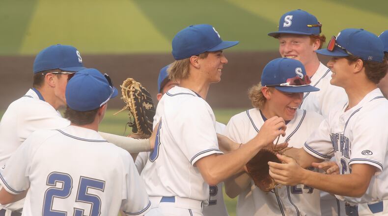 Springboro celebrates after Jacob Rhinehart, center, recorded a strikeout to end the game against Beavercreek in a Division I regional semifinal on Wednesday, June 4, 2025, at Miami University's McKie Field in Oxford. David Jablonski/Staff
