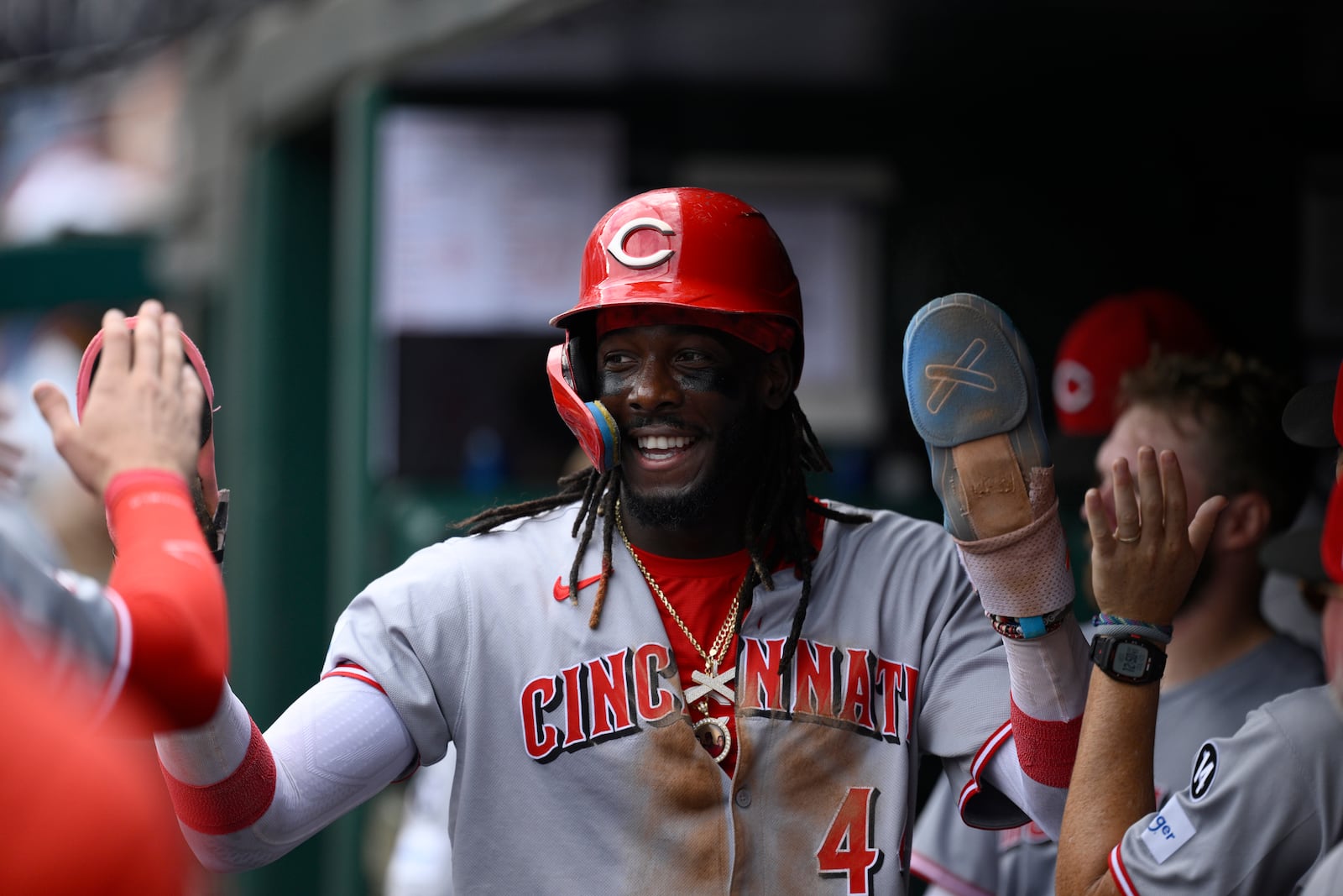Cincinnati Reds' Elly De La Cruz celebrates in the dugout after he scored on single by Jake Fraley during the fourth inning of a baseball game against the Washington Nationals, Wednesday, July 23, 2025, in Washington. (AP Photo/Nick Wass)