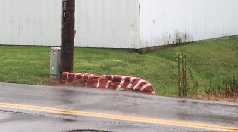 A concrete head wall just off of South Riverview Avenue in Miamisburg has become a traffic hazard since the reopening of Lower Miamisburg Road, according to resident Jeff Thatcher. Thatcher said he recently painted the barrier in hopes of making it more visible for motorists. City officials said they have started short-term ways to address the issue and are working on a long-term plan. FILE