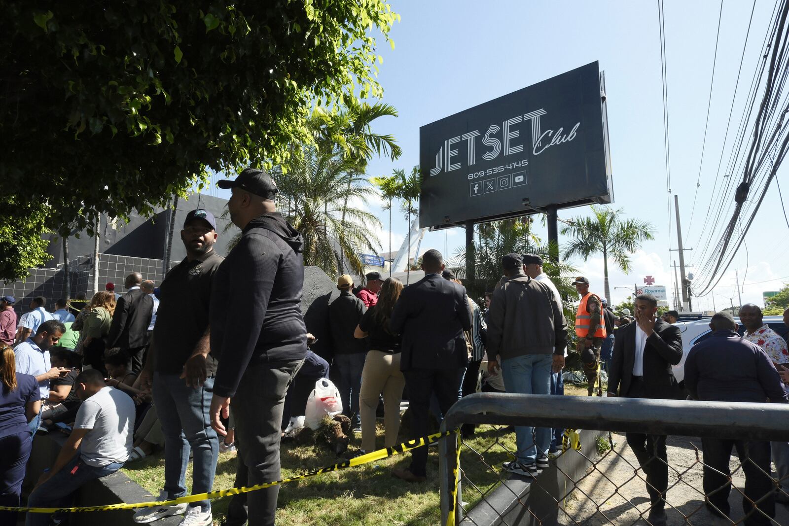 People gather outside the Jet Set nightclub after its roof collapsed during a merengue concert in Santo Domingo, Dominican Republic, Tuesday, April 8, 2025. (AP Photo/Ricardo Hernandez)