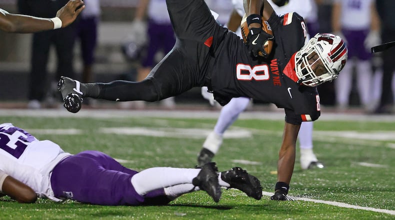 Wayne's Jamier Averette-Brown is upended by Middletown's Jazz Simpson during Friday's game. BILL LACKEY/STAFF