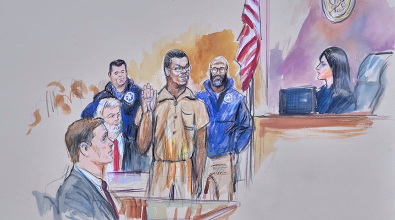 This courtroom sketch depicts Brian Cole Jr., 30, of Woodbridge, Va., the man accused of planting a pair of pipe bombs outside the headquarters of the Republican and Democratic national parties on Jan. 5, 2021, in Washington, being sworn in, Friday, Dec. 5, 2025 before U.S. Magistrate Moxila Upadhyaya, at Federal Court in Washington, as U.S. Attorney Charles Jones, seated left, and Defense Attorney John Shoreman, seated center, look on. (Dana Verkouteren via AP)