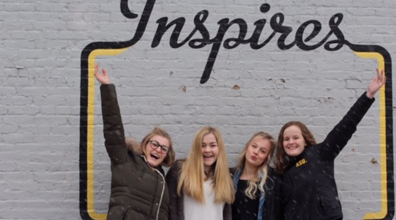 Oakwood High School sophomores ( left to right) Ryann Mescher, Dana Clark , Zoe Waller and Claire Parker launched the Femme Aid Collaborative to address period poverty in the Dayton area. They are pictured in the Oregon District.
