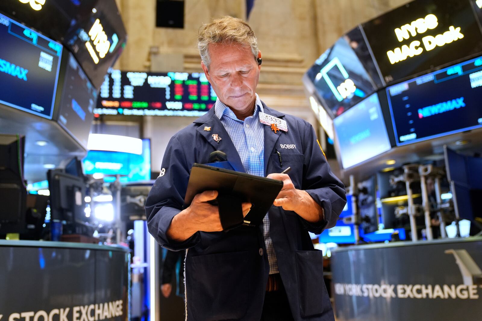 Bobby Charmak works on the floor at the New York Stock Exchange in New York, Thursday, April 3, 2025. (AP Photo/Seth Wenig)