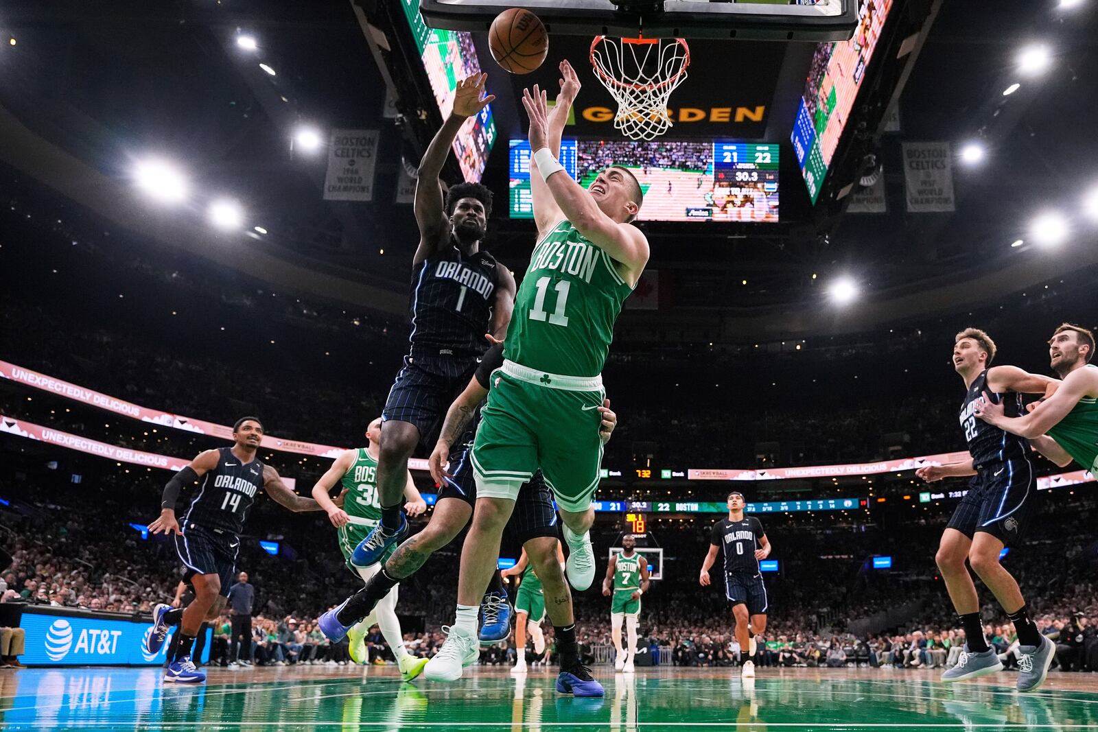 Boston Celtics guard Payton Pritchard (11) is fouled by Orlando Magic guard Anthony Black (0) during the first half in game 2 of a first-round NBA playoff basketball series, Wednesday, April 23, 2025, in Boston. (AP Photo/Charles Krupa)
