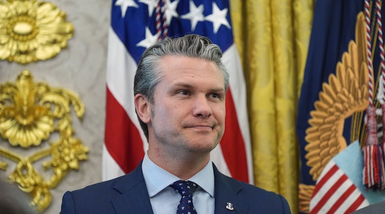 Defense Secretary Pete Hegseth listens as President Donald Trump speaks during the swearing in for Homeland Security Secretary Markwayne Mullin in the Oval Office of the White House, Tuesday, March 24, 2026, in Washington. (AP Photo/Alex Brandon)