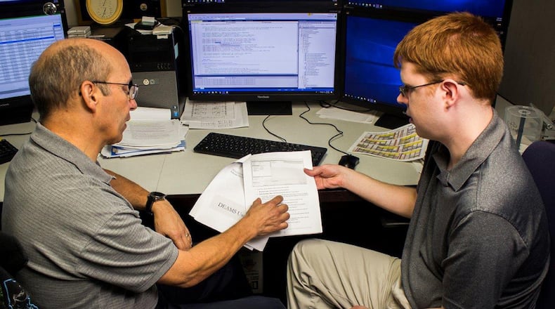 Sam Willoughby (right), a computer assistant intern with the Defense Institute of Security Cooperation Studies on Wright-Patterson Air Force Base, talks about changes to a database user guide with supervisor Bob Weber, Sept. 27. Willoughby is on the autism spectrum and was hired through a special initiative via Air Force Materiel Command’s Workforce Recruitment Program, which offers opportunities for college students who have disabilities. (U.S. Air Force photo/Jim Varhegyi)