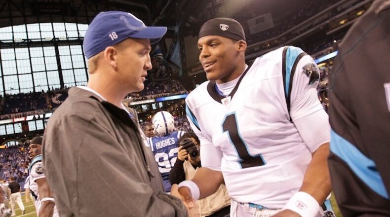 FILE - In this Nov. 27, 2011, file photo, injured Indianapolis Colts quarterback Peyton Manning meets with Carolina Panthers quarterback Cam Newton after an NFL football game in Indianapolis. For the next two weeks, until Peyton Manning's AFC champion Denver Broncos face Cam Newton's NFC champion Carolina Panthers in the 50th Super Bowl in Santa Clara, California, most of the focus will be on the two quarterbacks who were No. 1 overall draft picks 13 years apart. (AP Photo/AJ Mast, File)