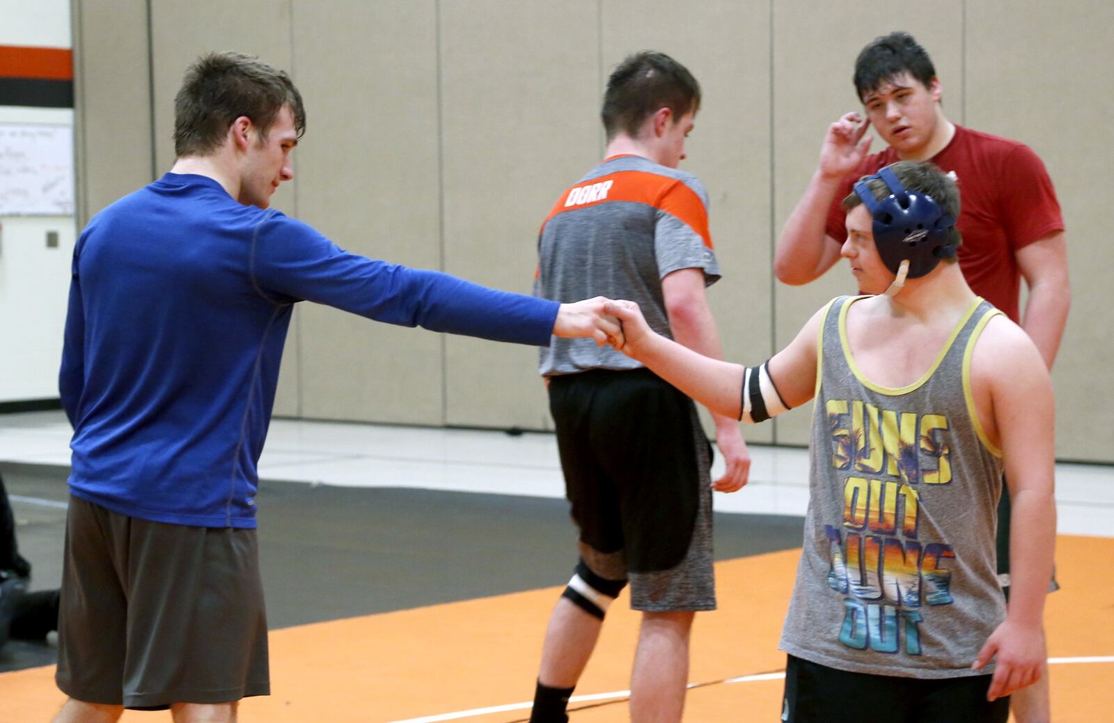 Josh Cook (left), a senior on the National Trail High School wrestling team and Brooks Henning, a student with Down Syndrome, have formed a friendship since Henning began wrestling with the team this year. LISA POWELL / STAFF