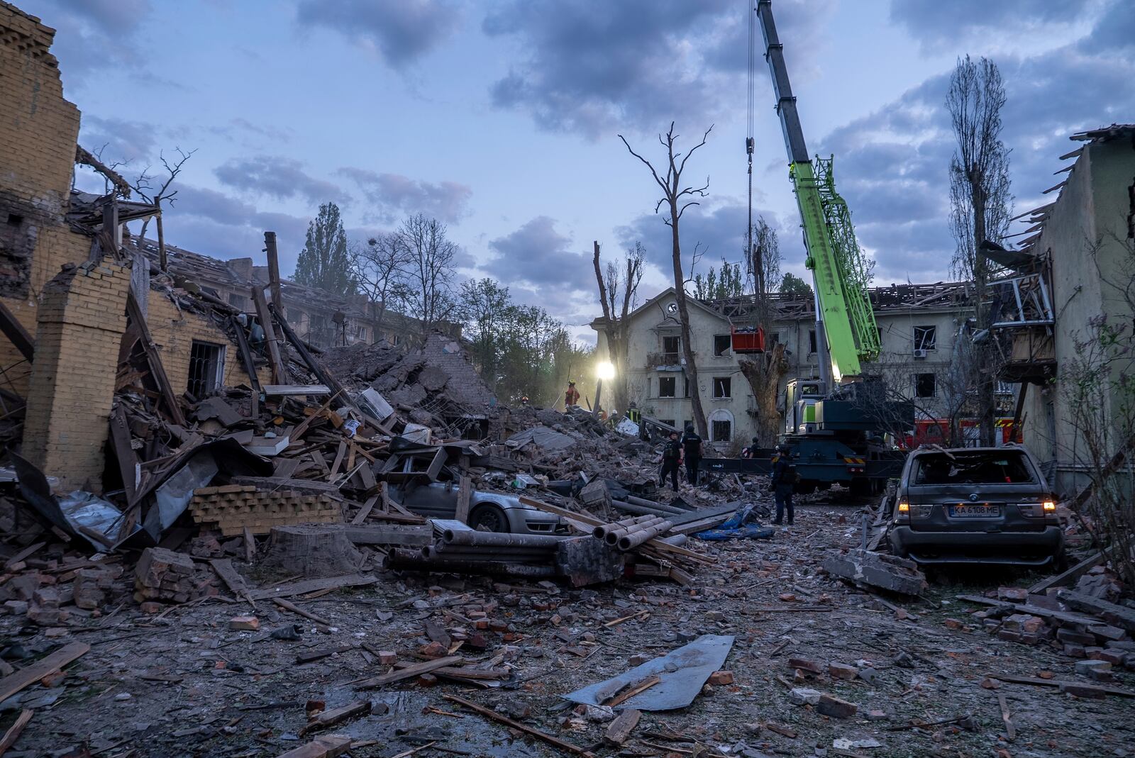 Rescue workers clear the rubble after a Russian strike in a residential neighborhood in Kyiv, Ukraine, Thursday, April 24, 2025. (AP Photo/Alex Babenko)