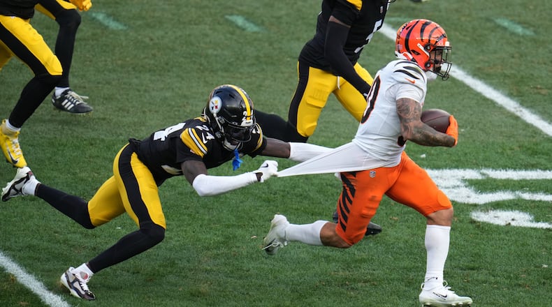 Pittsburgh Steelers cornerback Joey Porter Jr. (24) tries to tackle Cincinnati Bengals running back Chase Brown (30) during the second half of an NFL football game Sunday, Nov. 16, 2025, in Pittsburgh. (AP Photo/Gene J. Puskar)
