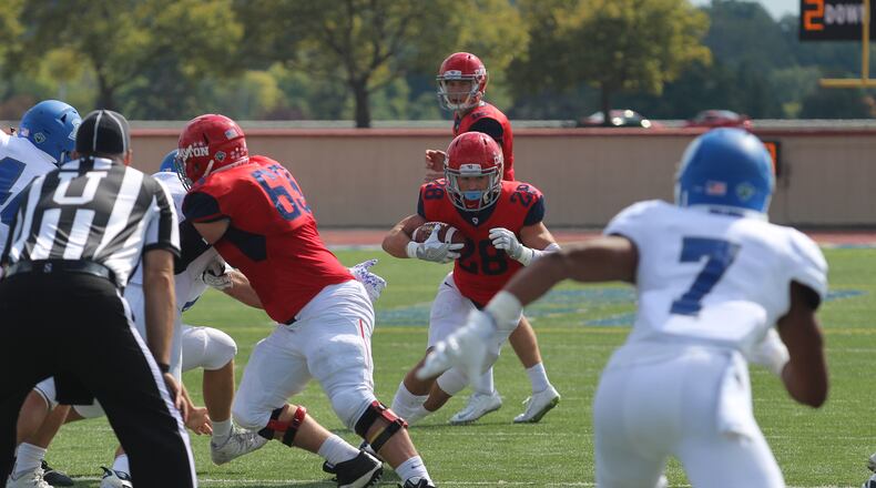 Tucker Yinger follows his blockers last season at Welcome Stadium against Drake. The Flyers beat the Bulldogs 35-10 as Yinger ran for 172 yards on 21 carries. MIKE HARTSOCK/STAFF