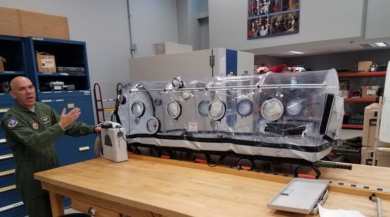 Lt. Col. Dwayne Rolniak, lab chief, discusses a patient isolation chamber that is being tested by the Agile Combat Support Directorate’s Aeromedical Test Lab for use on Air Force aircraft. The lab is responsible for testing all medical devices that are used on aeromedical evacuations, to ensure they will safely operate on the plane. The ACS Directorate has been involved in a number of improvement initiatives designed to increase efficiency and better support the warfighter. (U.S. Air Force photo/Brian Brackens)