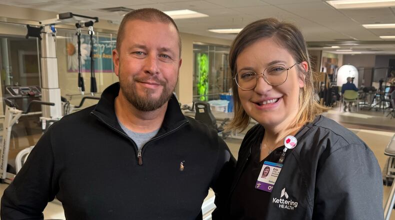 Pictured is Bill Wooley, a former Kettering Health Hamilton patient patient who sustained a severe spinal cord injury after an accident, with occupational therapy Erin Mueller, a member of his care team who helped him through his recovery efforts. MICHAEL D. PITMAN/STAFF