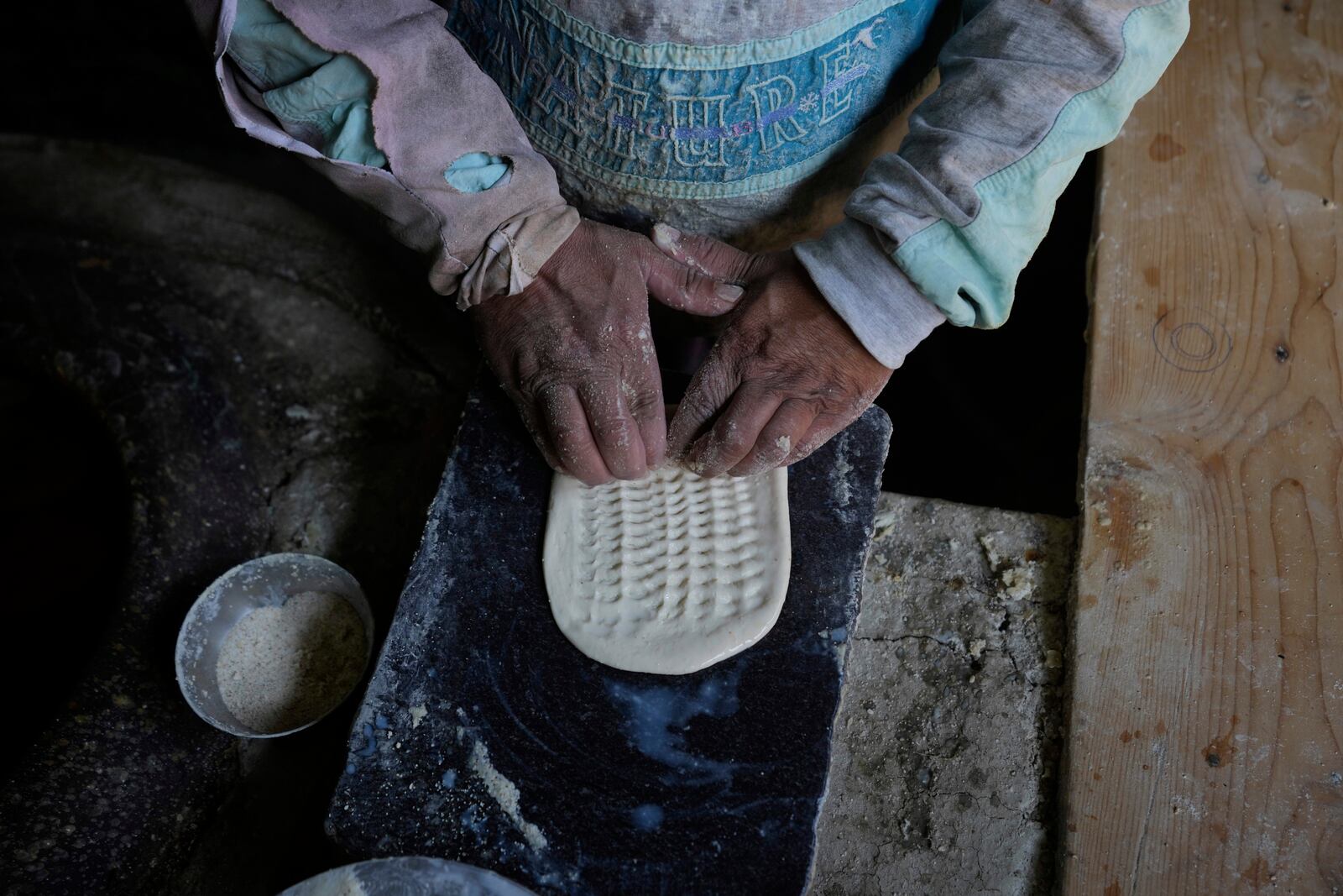 A Kashmiri baker works inside his shop in Srinagar, Indian controlled Kashmir, Thursday, April 24, 2025. (AP Photo/Mukhtar Khan)