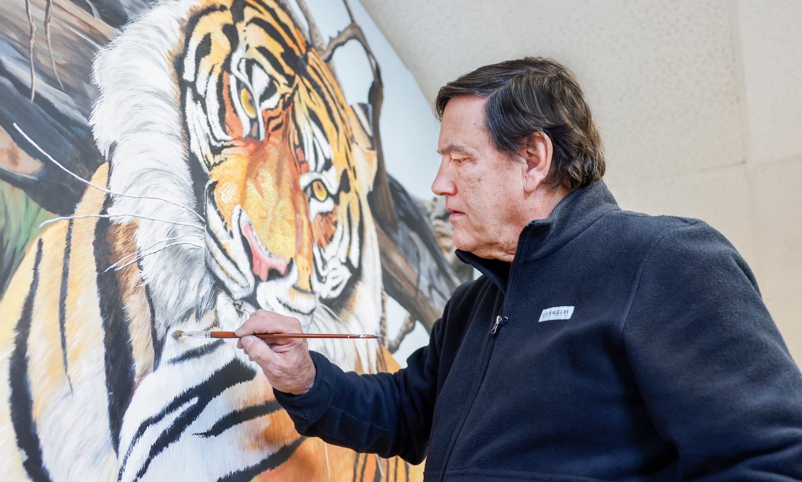 Gary Blevin works on a tiger painting in his art gallery on Thursday, December 18, 2025, in Springfield. JOSEPH COOKE/STAFF