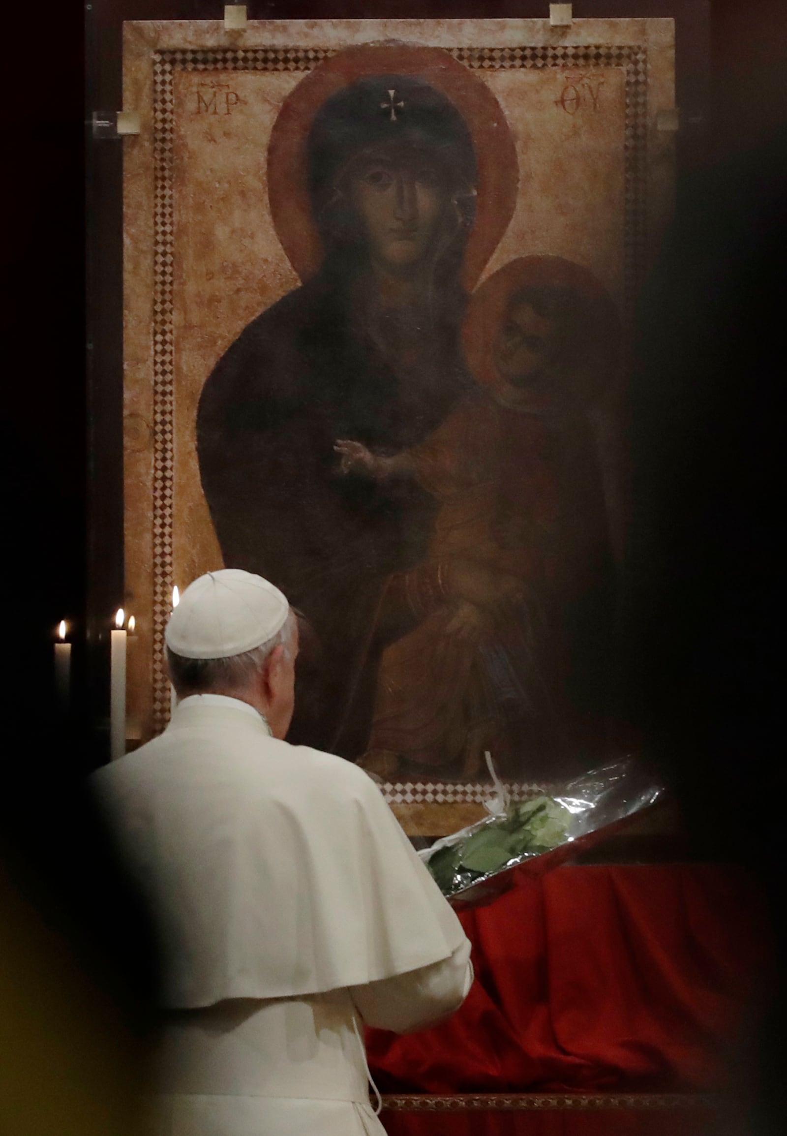 FILE - Pope Francis prays in front of a portrait of the Virgin Mary as he arrives in at St. Mary Major Basilica to preside over a vigil prayer, in Rome, Saturday, April 8, 2017. (AP Photo/Alessandra Tarantino, File)