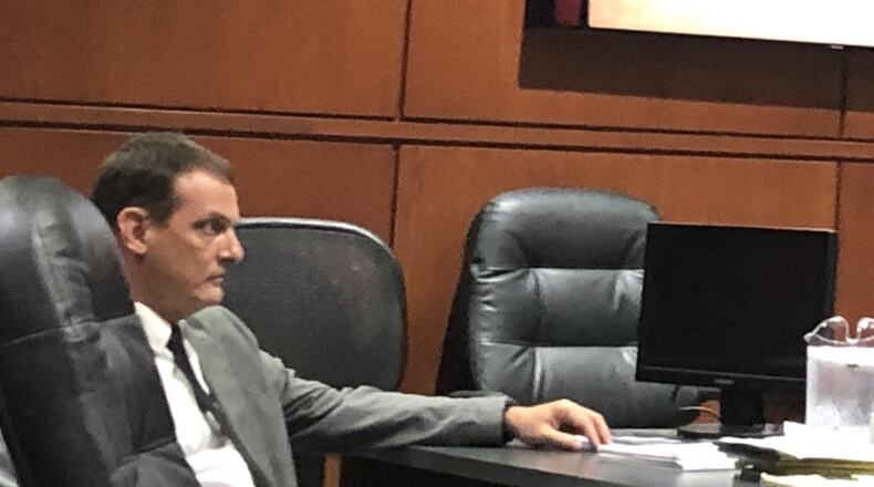Former Lebanon Correctional Institution Officer John Hinkle listens today during his trial on a felonious assault on an inmate charge. STAFF/LAWRENCE BUDD